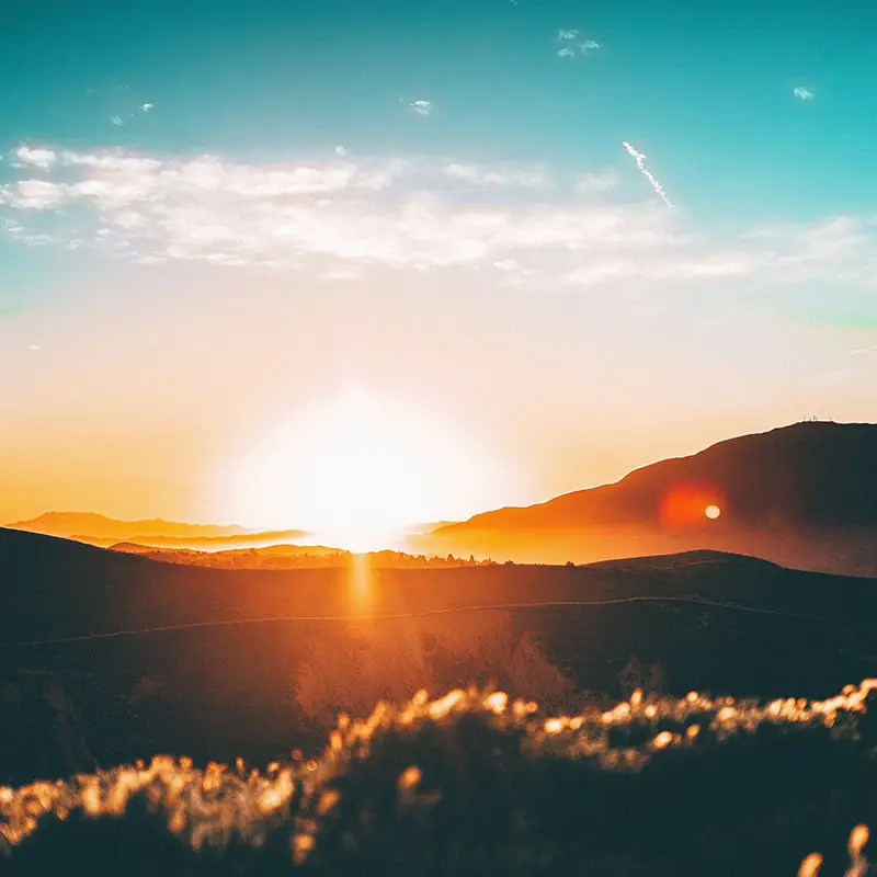 jordan-wozniak-xP_AGmeEa6s-unsplash Mountains with a sunset in the background